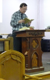 Professor David I. Roberts reading a passage from a 20th century Bible. 